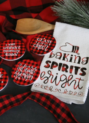 Diy Buffalo Plaid Gift Set including a Baking Spirits Bright tea towel and buffalo check coasters saying Glass of cheer, eat drink and be merry, and warm wishes and marshmallow kisses