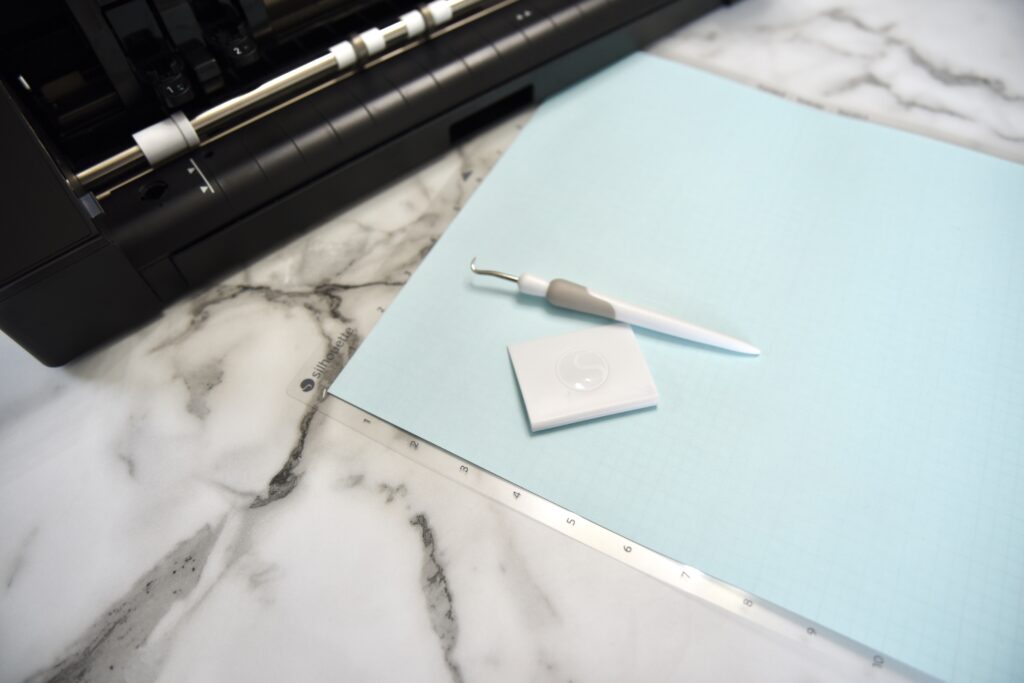 Silhouette Cameo machine with cutting mat, weeding tool, and scraping tool