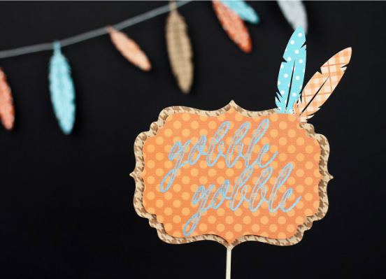 Thanksgiving Cake Topper with feathers and text saying gobble gobble