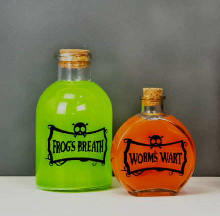 Halloween Potion Bottles - one says frogs breath on the label and the other says worm's wart
