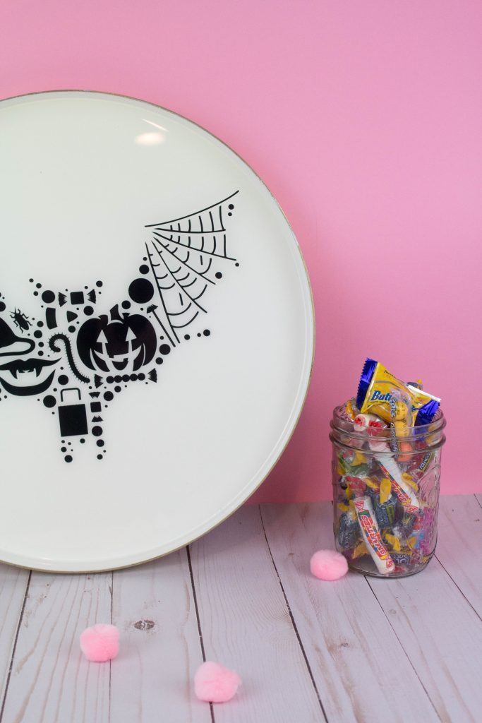Halloween Resin Plate - white plate with black design of jack o'lantern, spider web, candy, treat bag