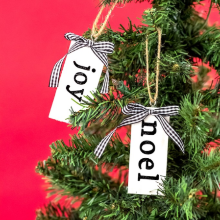 Diy Farmhouse Christmas Ornaments - white rectangles with blue gingham bows and text saying Joy and Noel