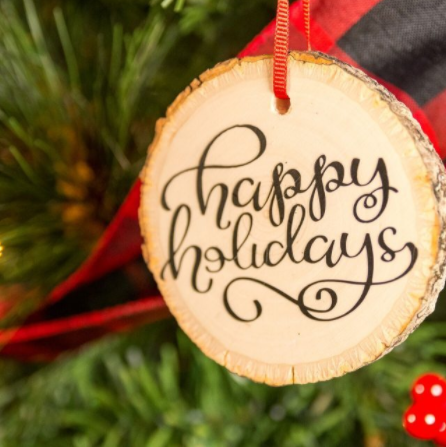 Wood slice Christmas ornament with Happy Holidays script on it