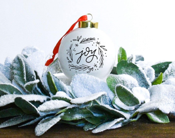 White Christmas Ornament with Joy and some holly branches on it
