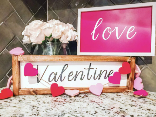 Farmhouse style wooden signs. One says love and the other one says Valentine. 