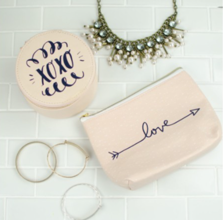 makeup bags customized with text saying love and an arrow or XOXO with squiggles