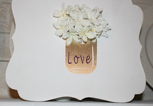 Vinyl Mason Jar Valentines Day Sign with the word love on the jar and flowers coming out of the jar