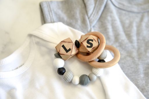 personalized baby teething ring with wooden rings, blocks, and beads