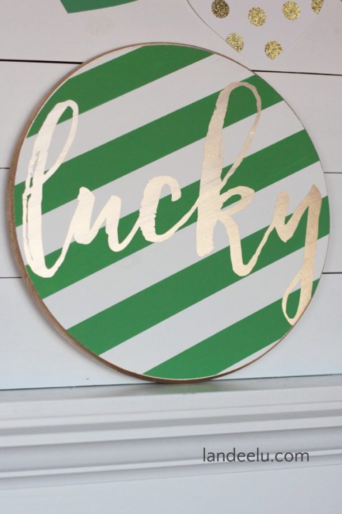 green and white striped sign with gold letters saying lucky on it