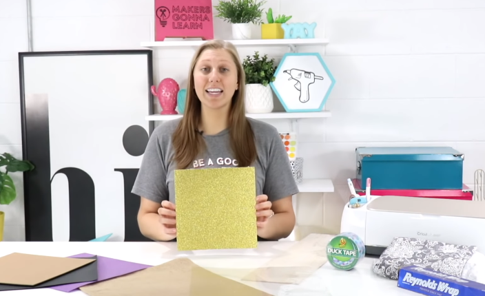 woman holding a piece of glitter cardstock