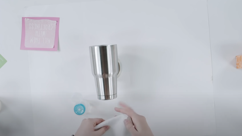 Using Rubbing Alcohol And A Paper Towel To Clean The Stainless Steel Tumbler